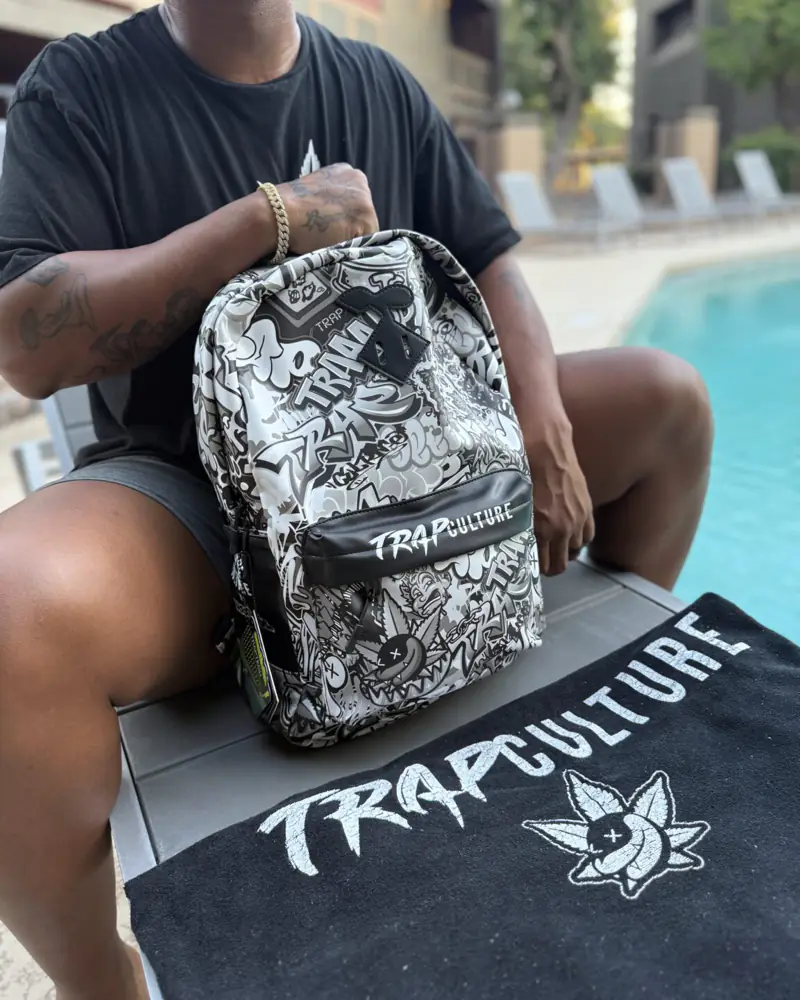 Trap Culture backpack and towel by the pool